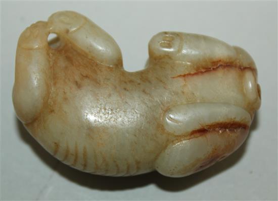 A Chinese pale celadon and russet jade recumbent figure of a bixi, 19th century, 5cm, wood stand